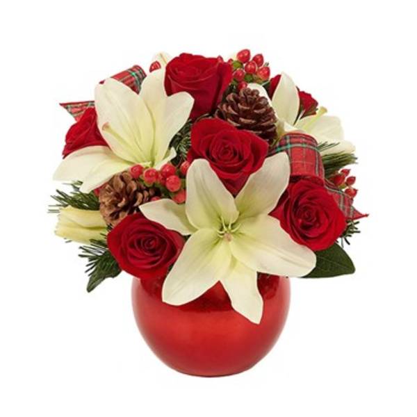 Red roses and white lilies in a red vase with pinecones and ribbon