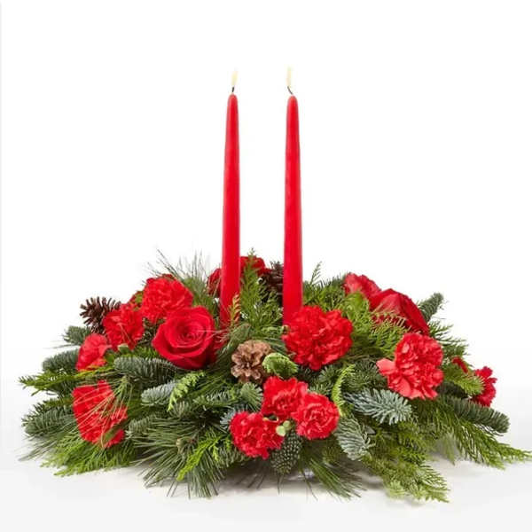 Red candle centerpiece with roses and carnations in evergreen