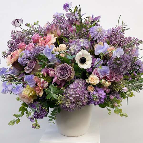 Lavender and pink mixed bouquet in a white vase
