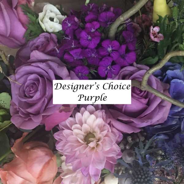 Purple floral arrangement with roses and mixed blooms