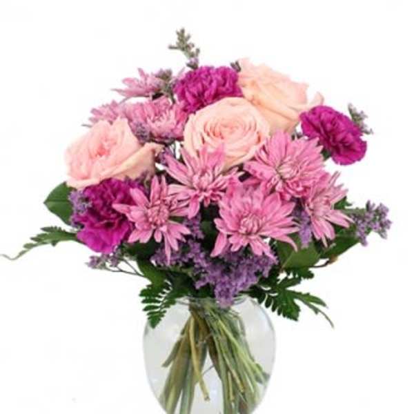 Pink and purple bouquet in a clear glass vase