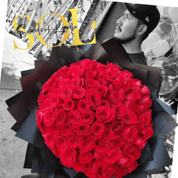 Large bouquet of red roses wrapped in black paper