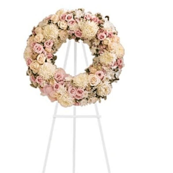Large pastel floral wreath on a white stand