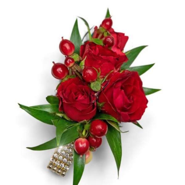 Red rose boutonniere with berries and green leaves