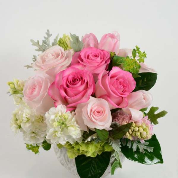 Pink and pale rose bouquet with white flowers in a vase