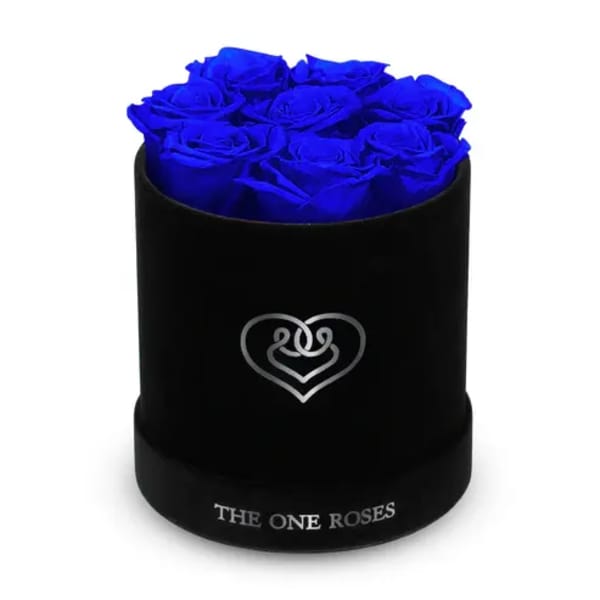 Blue roses arranged in a black round box