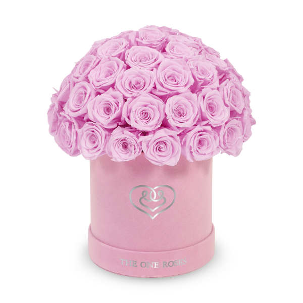 Pink roses arranged in a round pink hat box