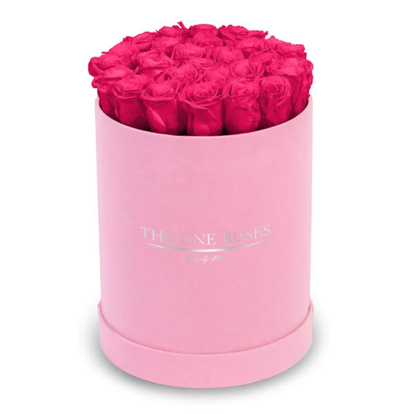 Hot pink roses arranged in a pink round box