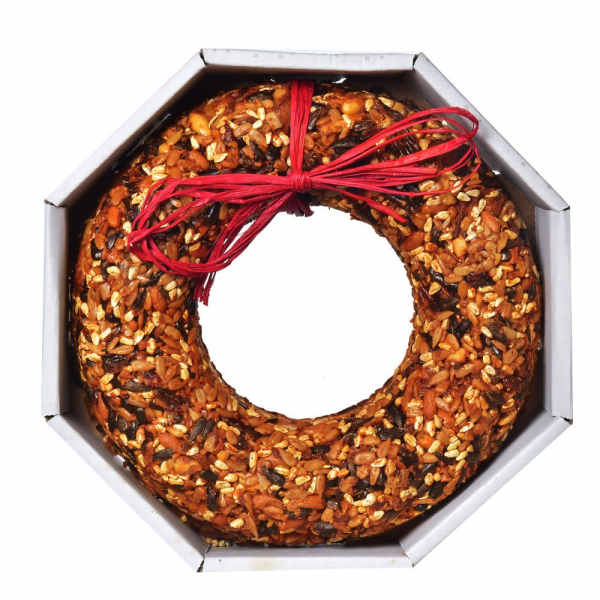 Ring-shaped seed cake in a box tied with a red ribbon