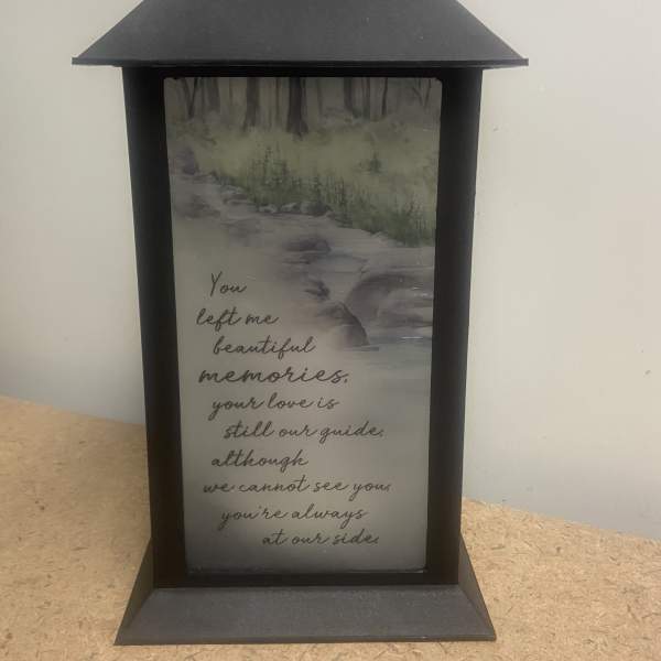Black memorial lantern with a printed sympathy message
