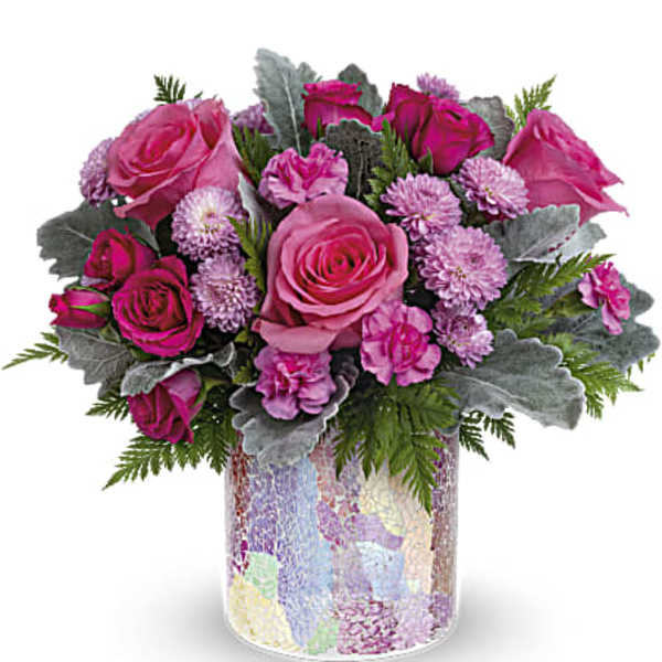 Pink roses and pom-pom flowers in a mosaic glass vase