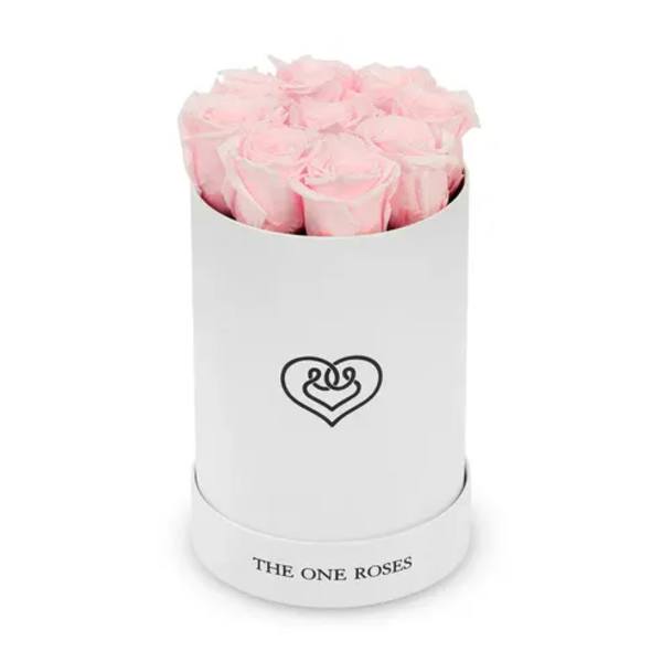 Pink roses arranged in a white cylindrical box with a heart logo