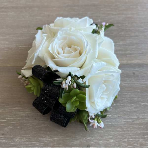 White rose bouquet with succulents and a black ribbon