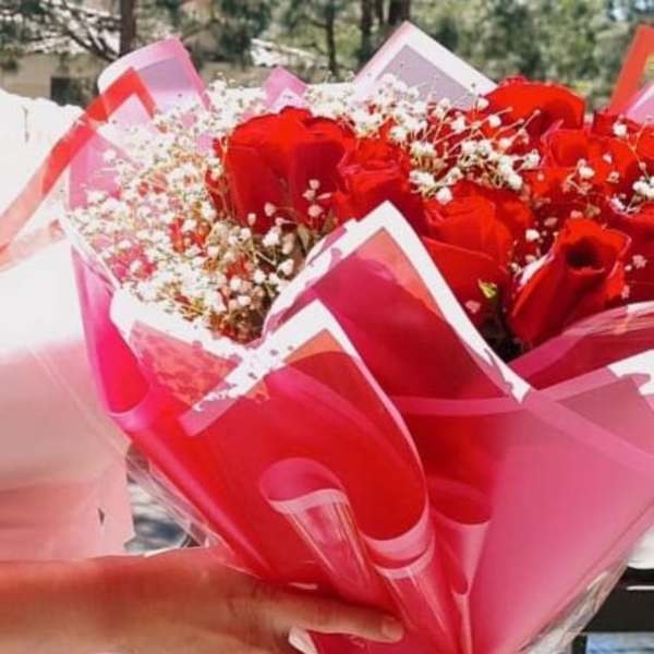 Red rose bouquet wrapped in pink and red paper