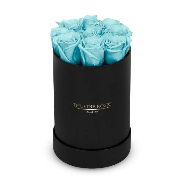 Blue roses in a black round box