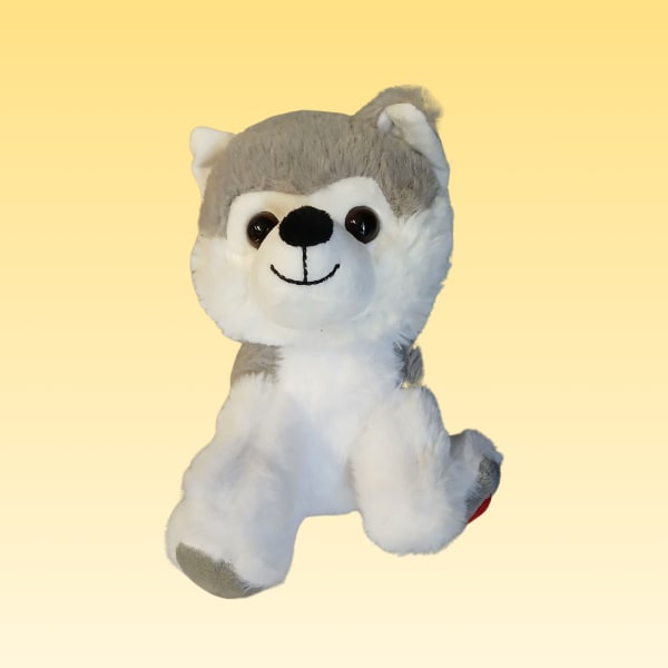 Gray and white plush husky toy on a plain yellow background