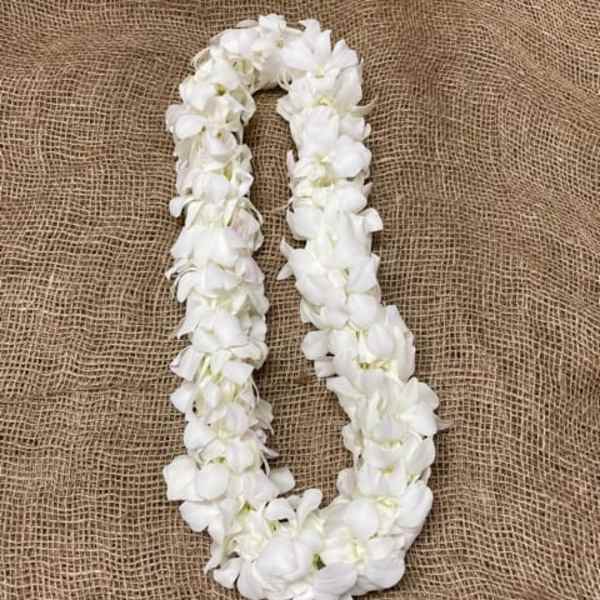 White flower lei on burlap fabric