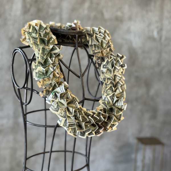 Money lei draped over a metal dress form
