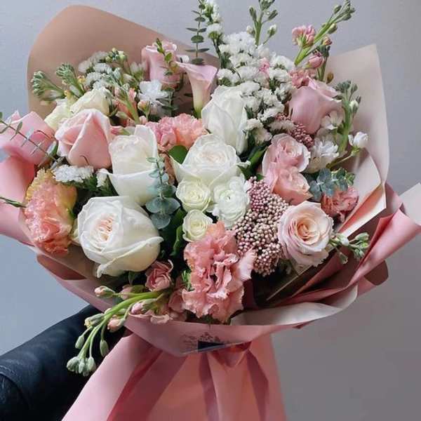 Pink and white rose bouquet wrapped in pink paper