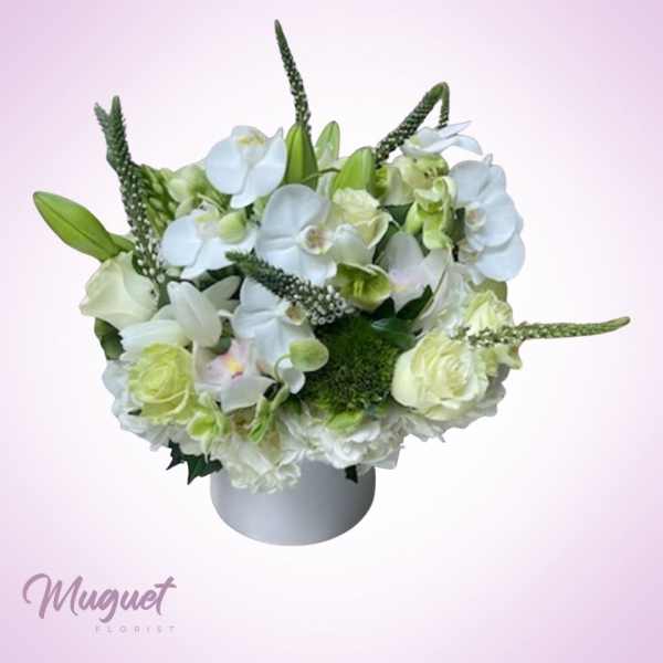 White floral arrangement in a round white vase