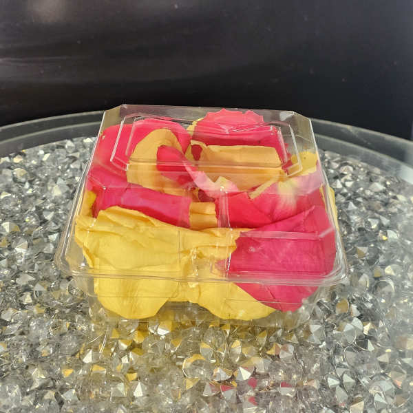 Clear plastic box of pink and yellow rose petals
