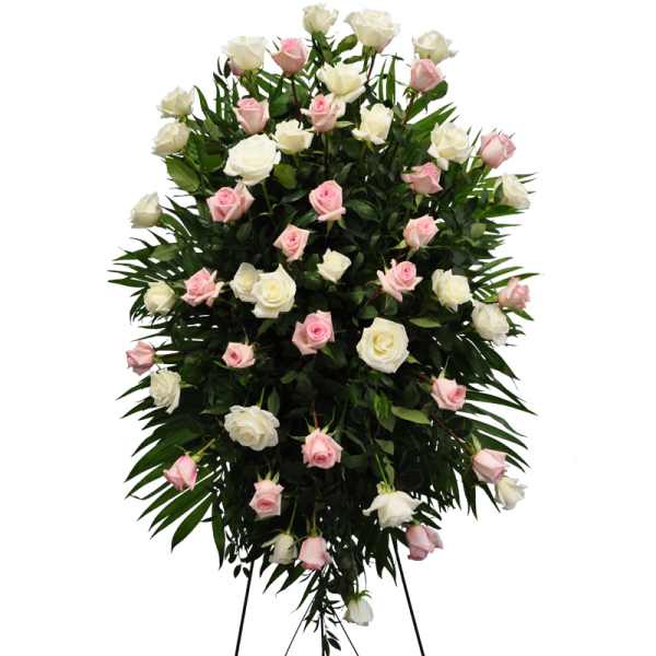 Standing spray of pink and white roses on a black easel