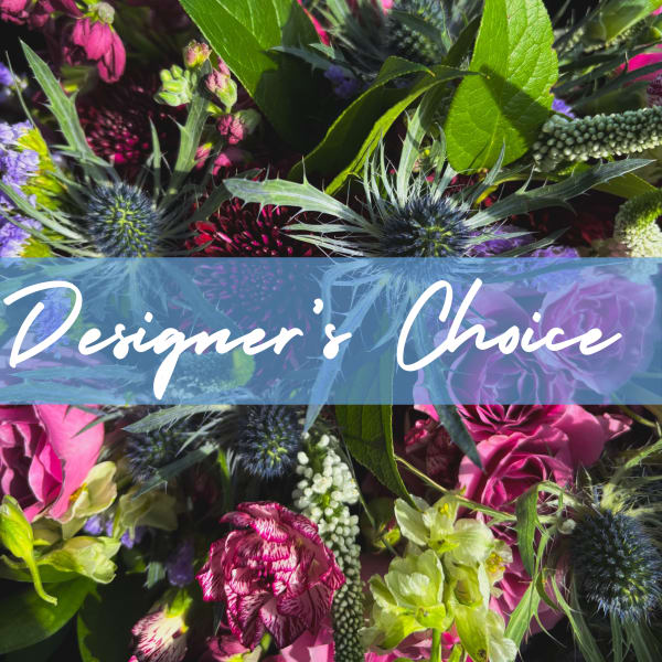 Close-up of a bright mixed bouquet with pink roses, carnations, and blue thistle-like blooms.