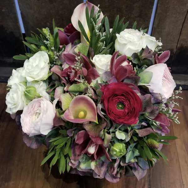 Bouquet of white roses, burgundy ranunculus, and pink calla lilies