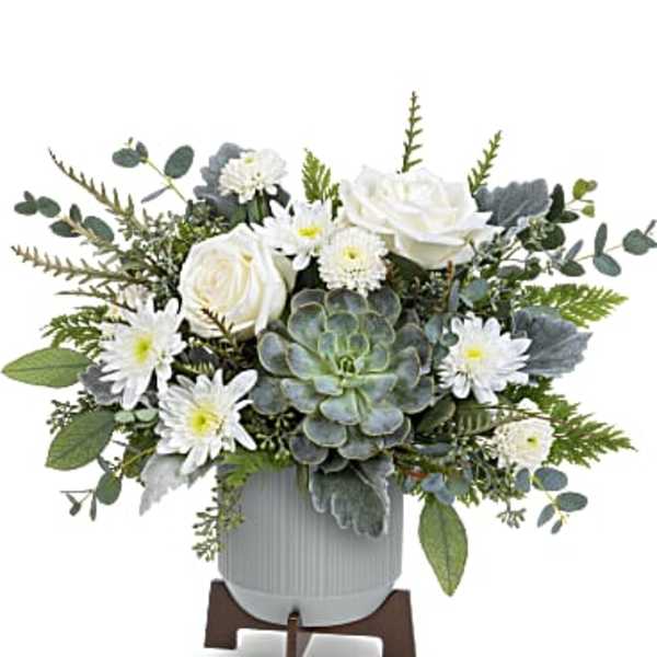White roses and daisies arranged in a gray pot with a succulent centerpiece