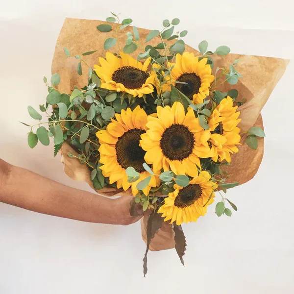 Bouquet of sunflowers wrapped in brown paper