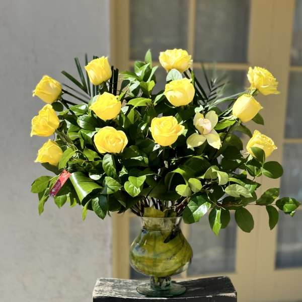 Yellow roses arranged in a clear glass vase