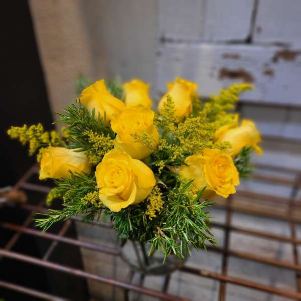 Bouquet of yellow roses with sprigs of greenery