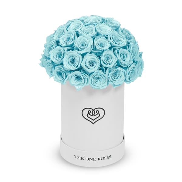 Bouquet of light blue roses in a white cylindrical box