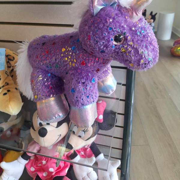 Purple unicorn plush toy with glitter and iridescent accents