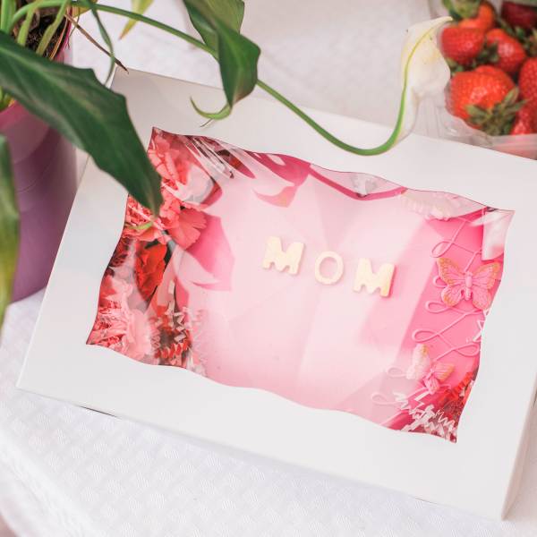 Pink gift box with MOM lettering and butterfly decorations