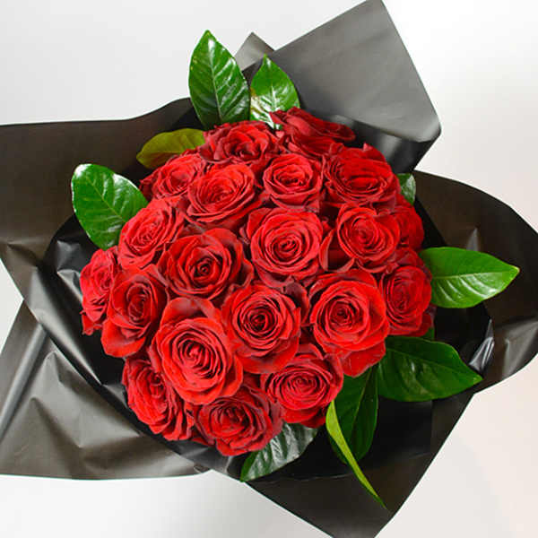 Bouquet of red roses wrapped in black paper