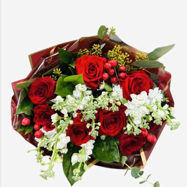 Bouquet of red roses with white flowers and greenery in burgundy wrap
