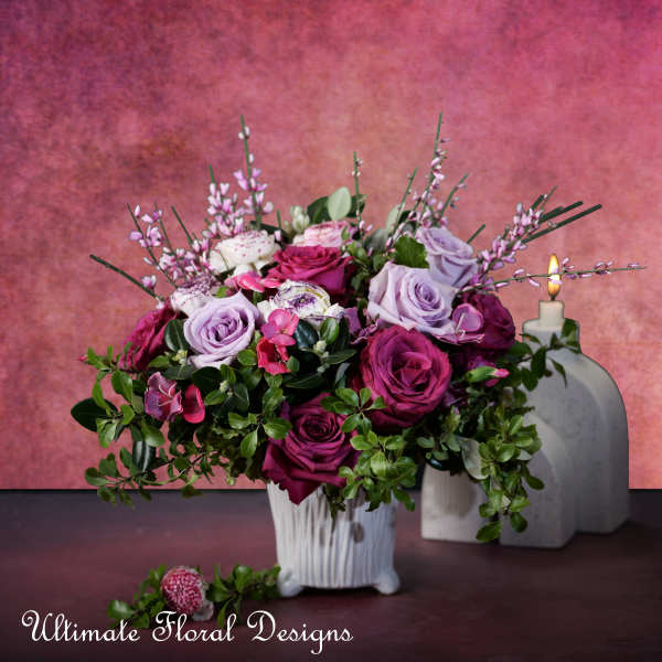 Bouquet of pink and lavender roses in a white vase
