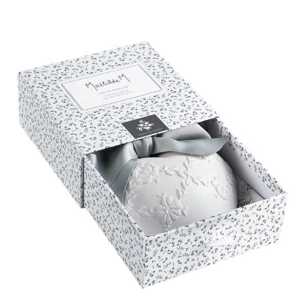 Decorative gift box with a white embroidered item and gray ribbon