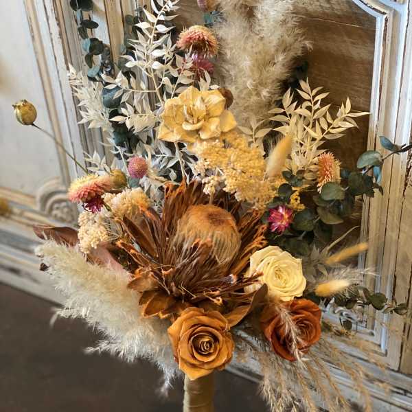Dried bouquet with orange and cream roses and feathery pampas grass