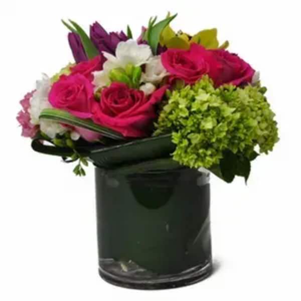 Bouquet of pink and white flowers in a dark glass vase