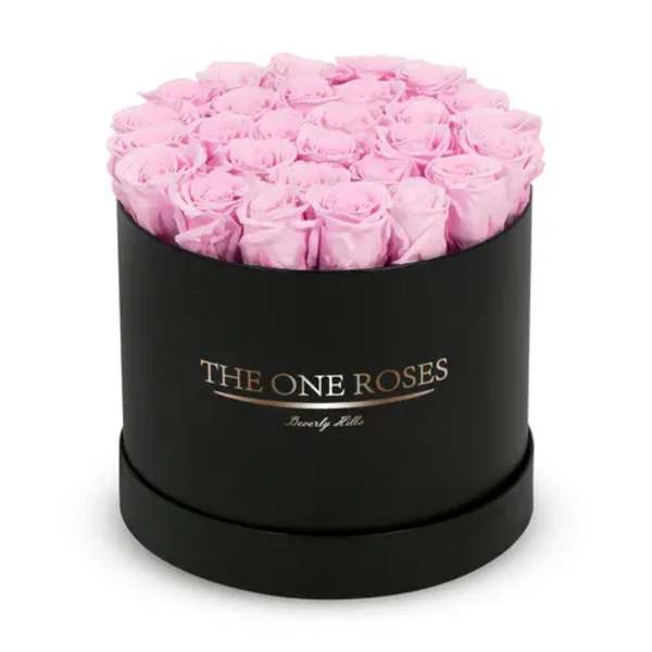 Pink roses arranged in a black round box