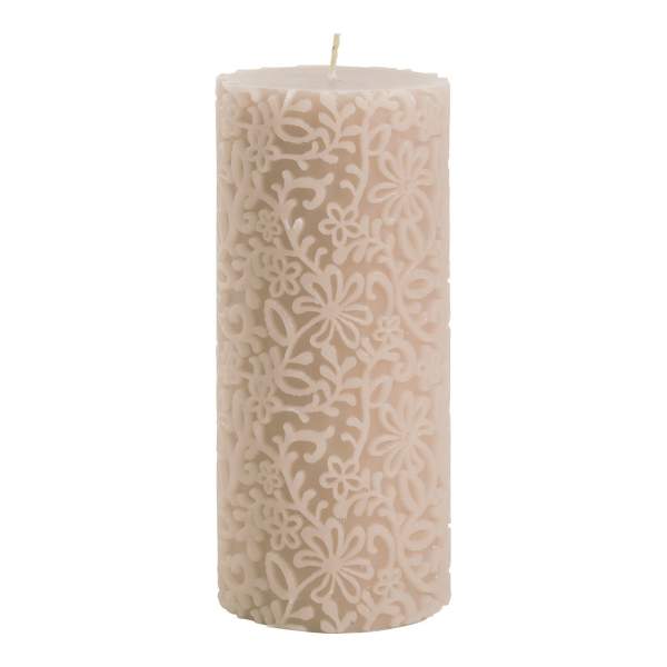 Cream-colored pillar candle with a floral cutout pattern