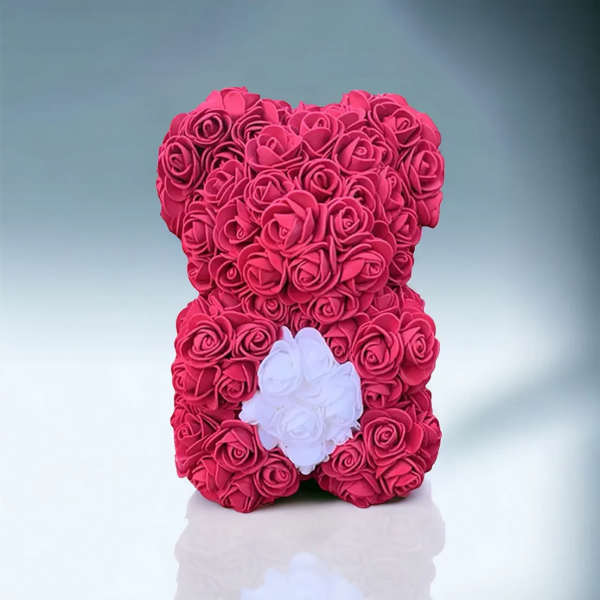 Pink rose teddy bear with a white heart on its chest