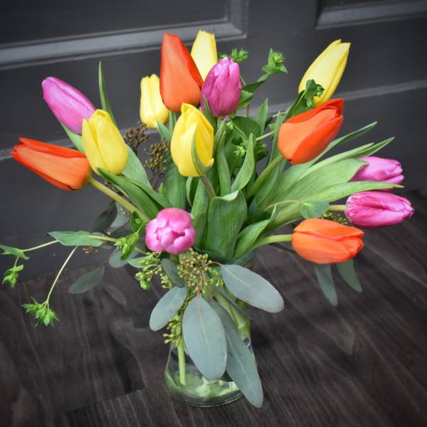 Bouquet of multicolored tulips in a glass vase