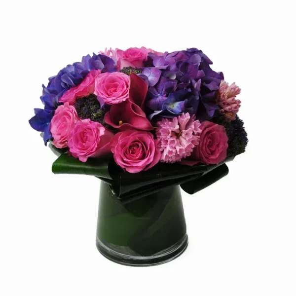 Pink and purple bouquet in a dark vase