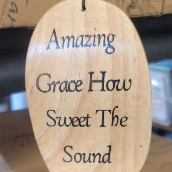 Oval wooden hanging sign with the words "Amazing Grace"