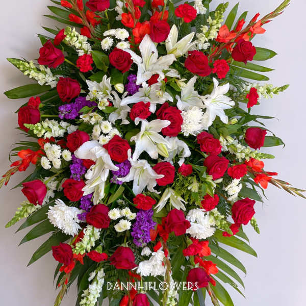 Large standing spray of red, white, and purple flowers