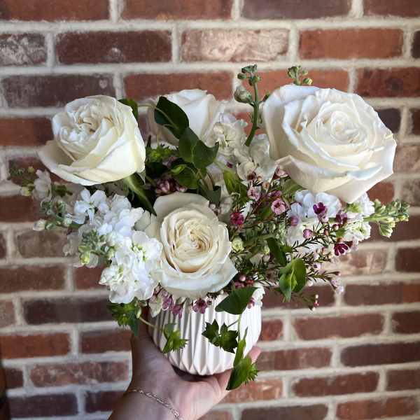 White rose bouquet in a ribbed white vase