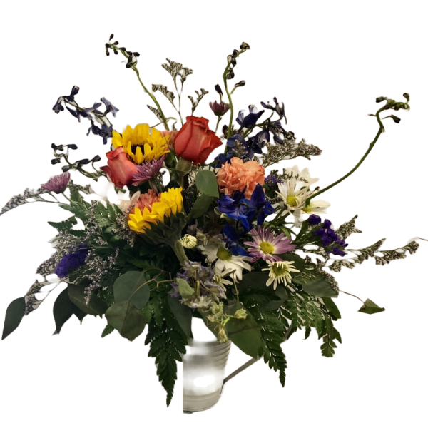Mixed bouquet with sunflowers, roses, and daisies in a white vase